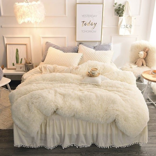 An off-white faux fur duvet set draped over a bed, looking soft and inviting.