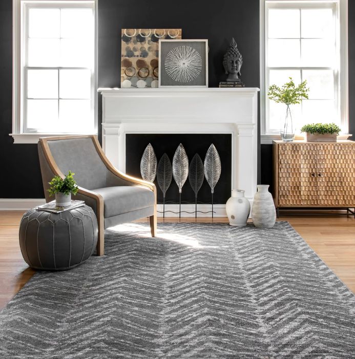 A stylish grey chevron-patterned rug, seamlessly complementing the decor of a cozy living room.