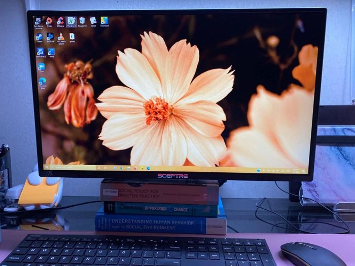 The monitor is set up on a desk, providing an enhanced workspace.