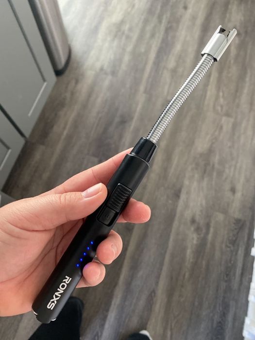 Image of a reviewer holding the rechargeable lighter in their hand