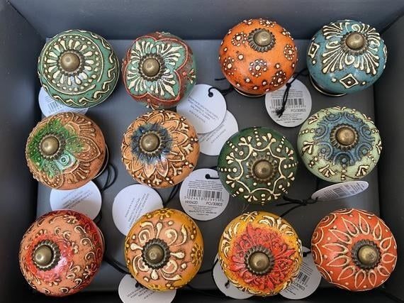 A collection of doorknobs in a variety of vibrant colors