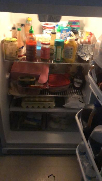 A review image showing a cluttered and disorganized fridge.