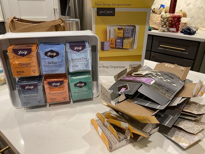 A reviewer shares a photo of their newly organized tea collection, with multiple boxes neatly replaced by the efficient organizer, freeing up space.