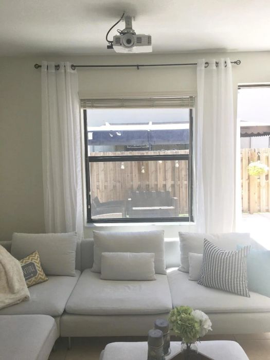 A reviewer's living room featuring white sheer curtains hanging gracefully on the windows.