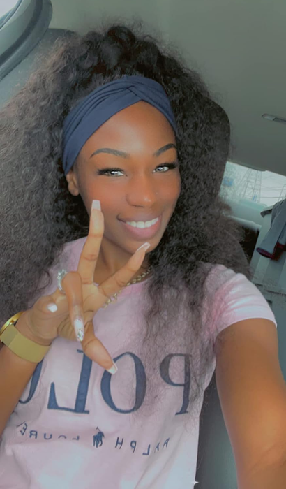 Person with curly hair wearing a headband