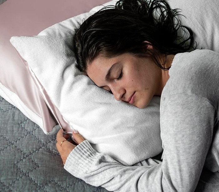 A model sleeping on the towel side of the pillowcase.