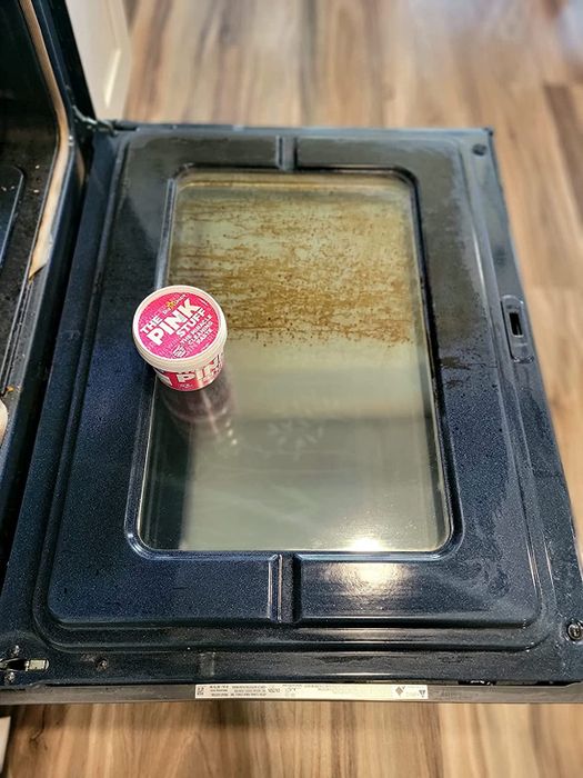 A reviewer's oven before and after using The Pink Stuff