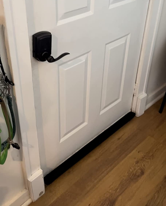 A photo from a reviewer showing the door draft stopper installed on a door