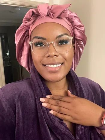Reviewer wearing the mauve satin bonnet
