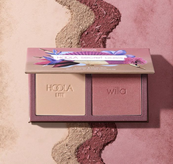 Benefit Cosmetics Hoola Lite and Willa bronzer and blush duo packaging showcased on a mixed powder background.