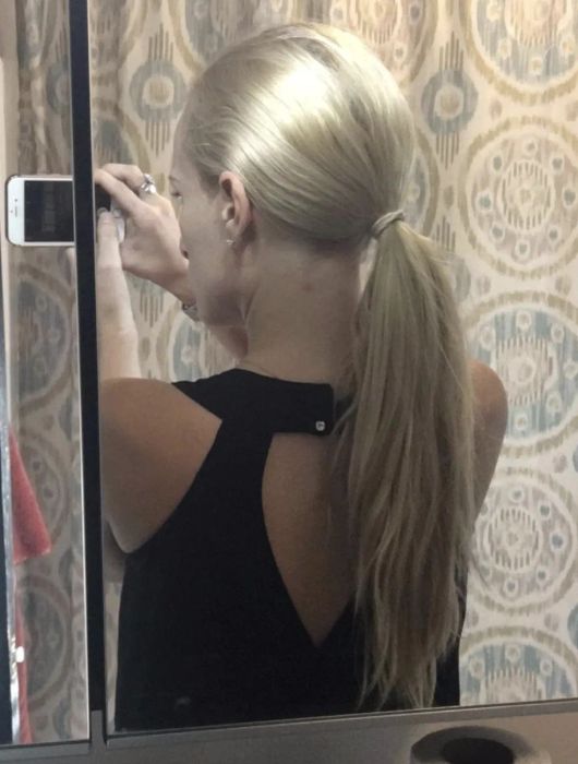 Reviewer styling their hair into a sleek ponytail