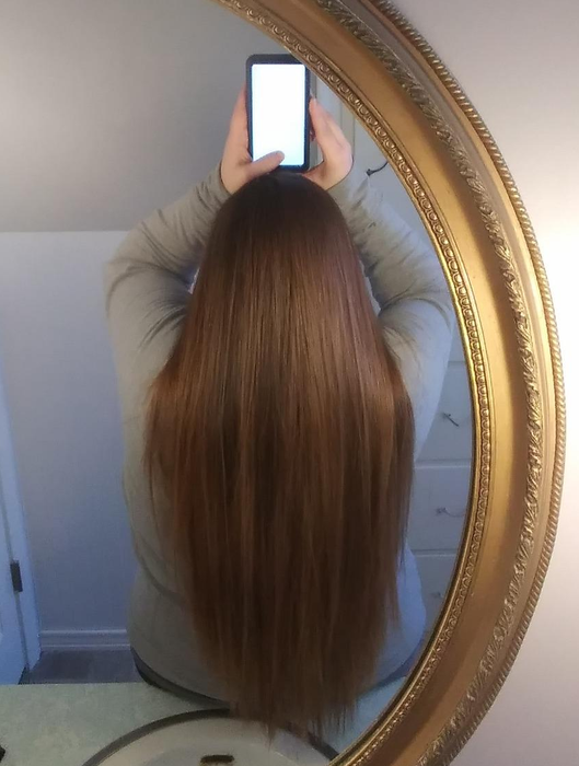the same reviewer with their hair looking straight, sleek, and shiny