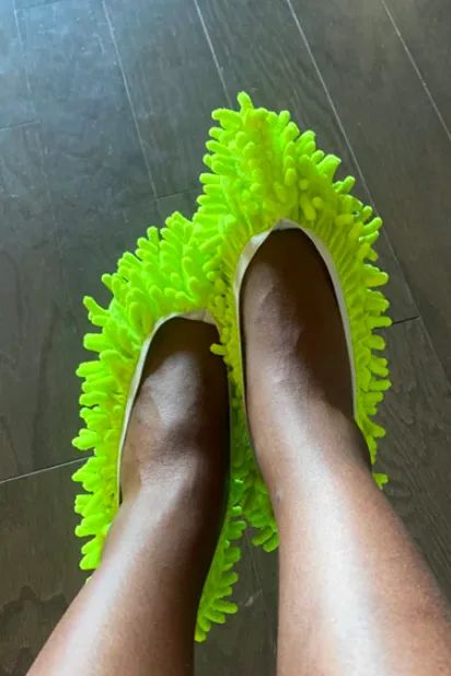 A customer review photo of someone wearing the mop slippers.