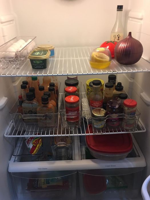 The same fridge after using the bins, now looking more organized with plenty of extra space.