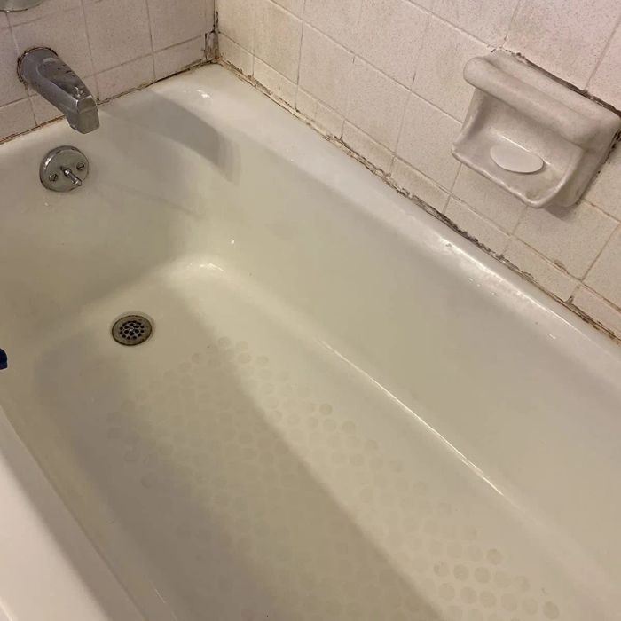 The same reviewer’s photo showing a sparkling clean white bathtub after using the drill brush