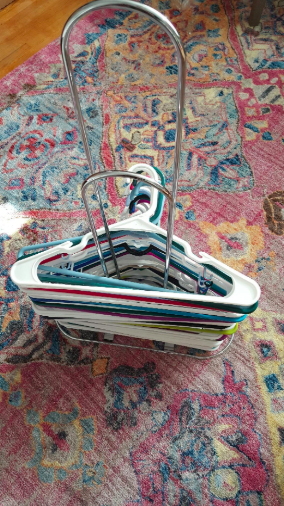 The same reviewer's picture now shows the hangers neatly organized on the stacker.