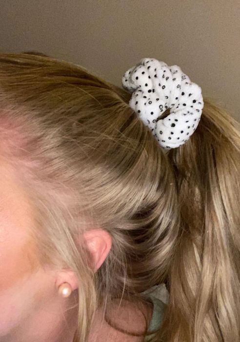 A reviewer wearing a polka-dotted microfiber scrunchie