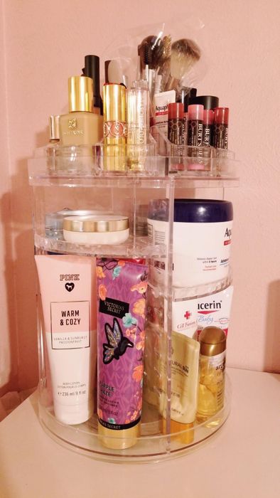 Another reviewer's clear rotating organizer with a variety of products arranged on it