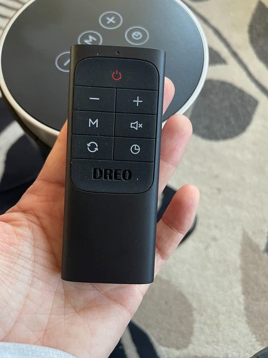 A photo of a remote control in the reviewer's hand