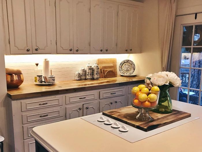 A reviewer's kitchen featuring cabinets with elegant under-cabinet lighting installed for a stylish, modern touch.