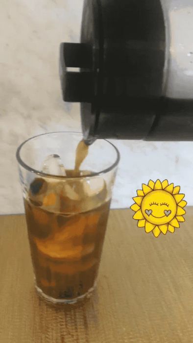 A gif showing cold brew coffee being poured into an ice-filled glass.
