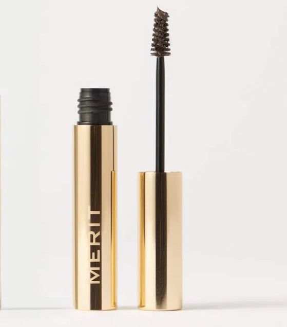 Gold tube of Merit tinted brow gel with an open wand, revealing the bristle brush