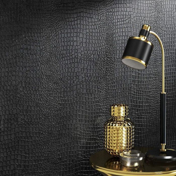 A gold lamp and a patterned vase placed on a reflective table, set against a textured wall that enhances the ambiance.