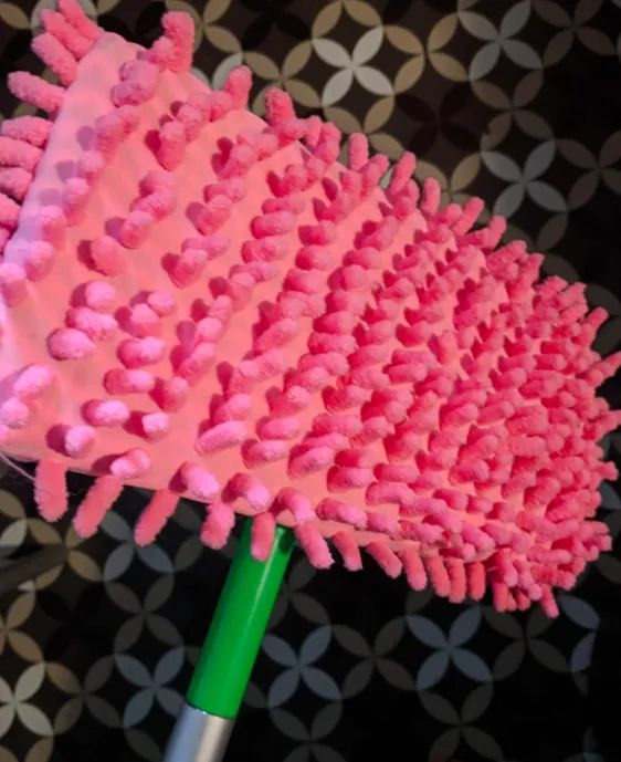 A customer review photo showing the slippers fitted onto their Swiffer.