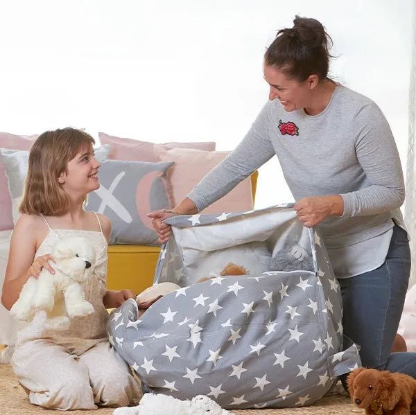 A small child and their parent packing the beanbag with toys