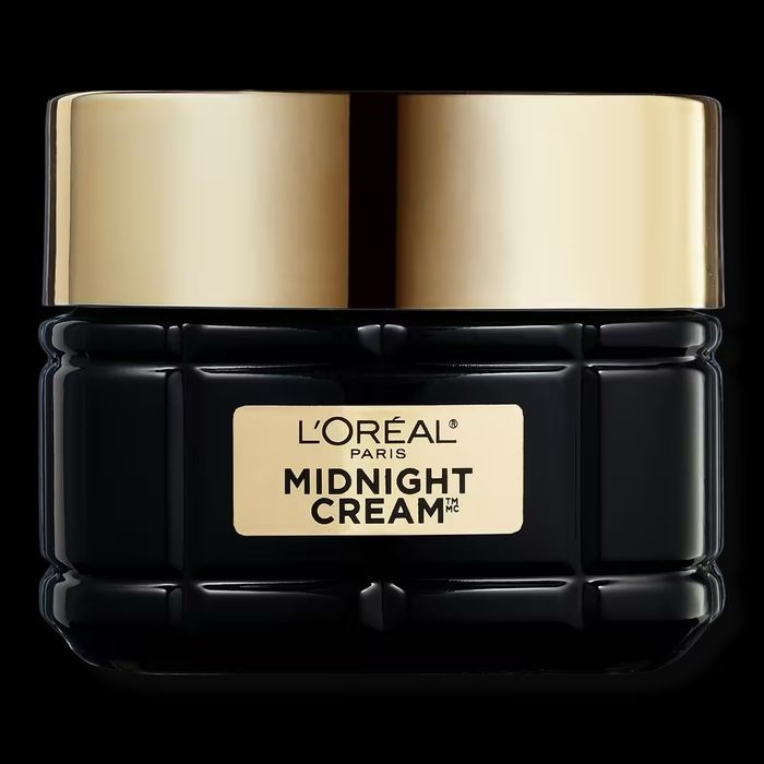L'Oréal Paris Midnight Cream jar with a gold lid, designed for skincare use.