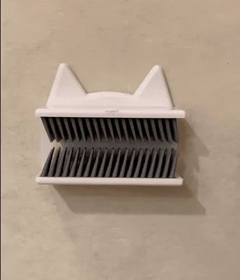 A gif showing a reviewer using the hair catcher to collect hair