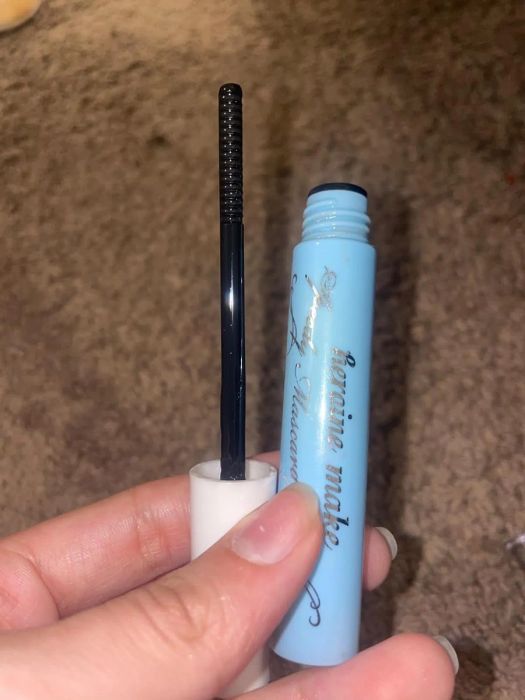A reviewer photo of the mascara remover, which looks like a tube of mascara and features a wand similar to a regular mascara wand