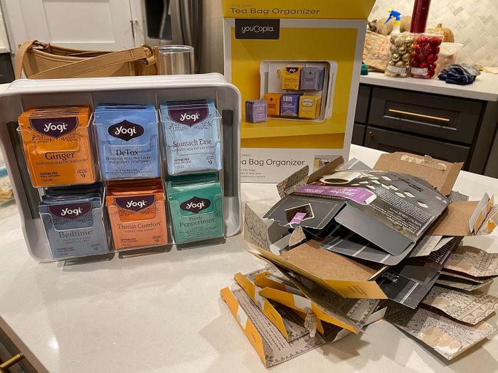 Reviewer’s double-sided organizer filled with tea bags, with the empty boxes placed next to it