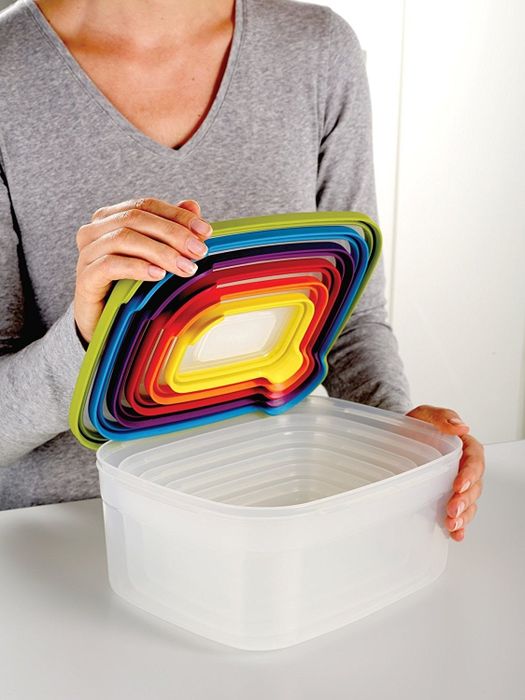 A model demonstrates how the pill organizer trays nest neatly inside each other for compact storage.