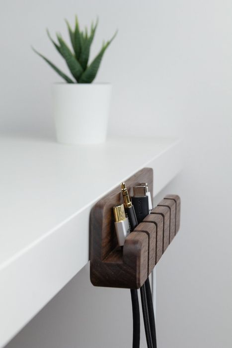 The same wooden organizer attached to the side of a desk, rather than sitting on top, offering a sleek storage solution.