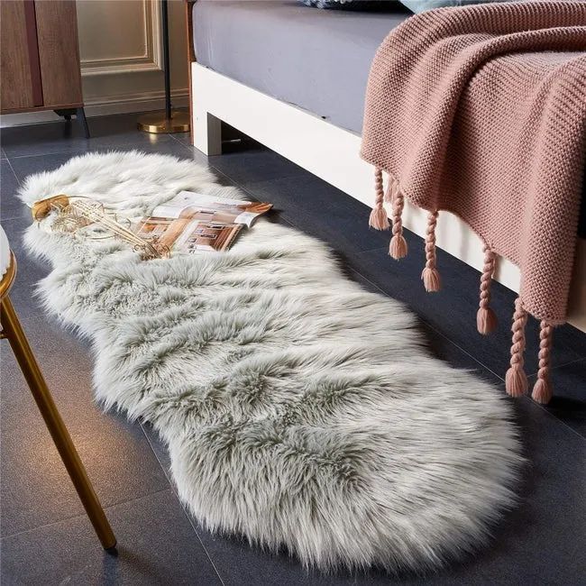 Faux fur rug placed beside a bed