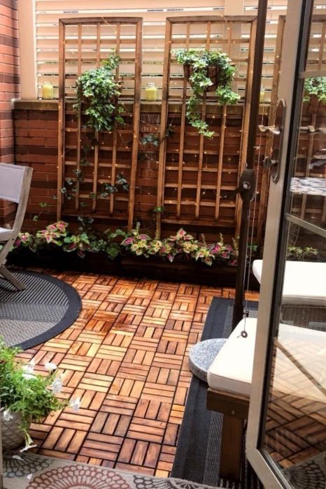 A backyard patio floor covered with interlocking tiles.
