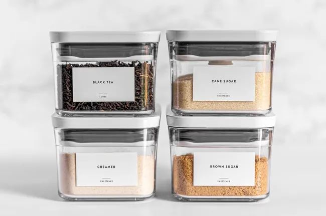 Pantry labels marking black tea, cane sugar, creamer, and brown sugar, all neatly organized.
