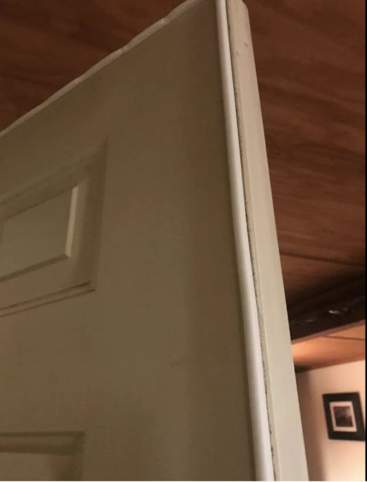 A reviewer photo showing the soundproofing strip installed on their door.