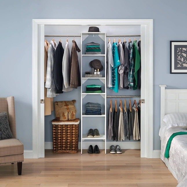 a white wooden closet kit designed to hang clothes and store accessories