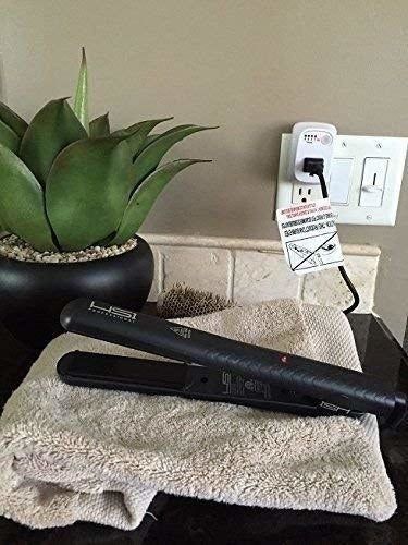 A flat iron plugged into the outlet