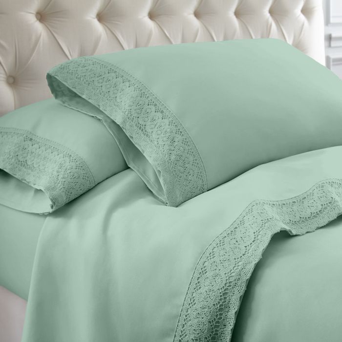 Pillows and sheets with lace trim on a tufted headboard bed, elegantly featured in a shopping article, highlighting their delicate details.