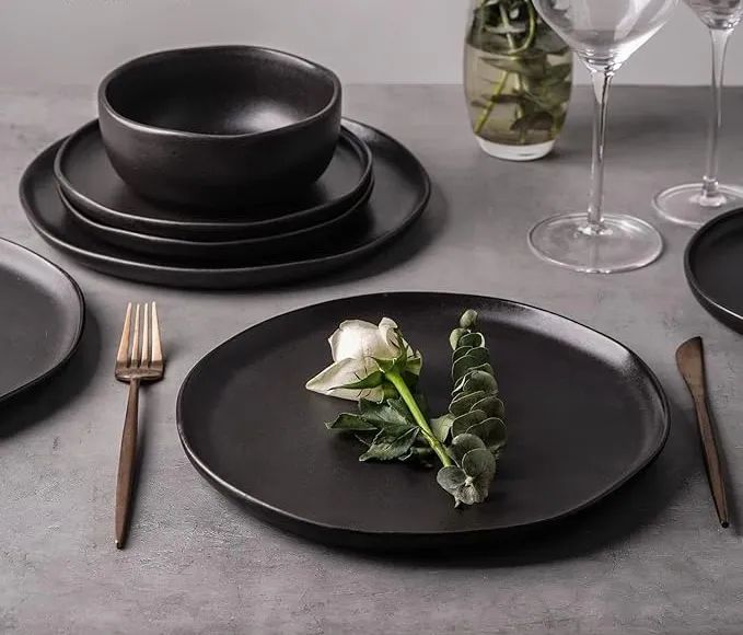 One of the matte black plates featuring a white rose design