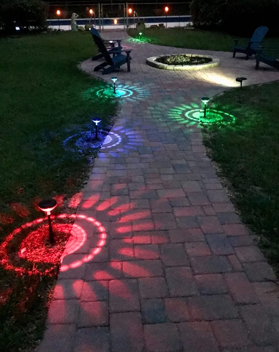 A reviewer's photo showing the lights installed, casting vibrant multicolored lights