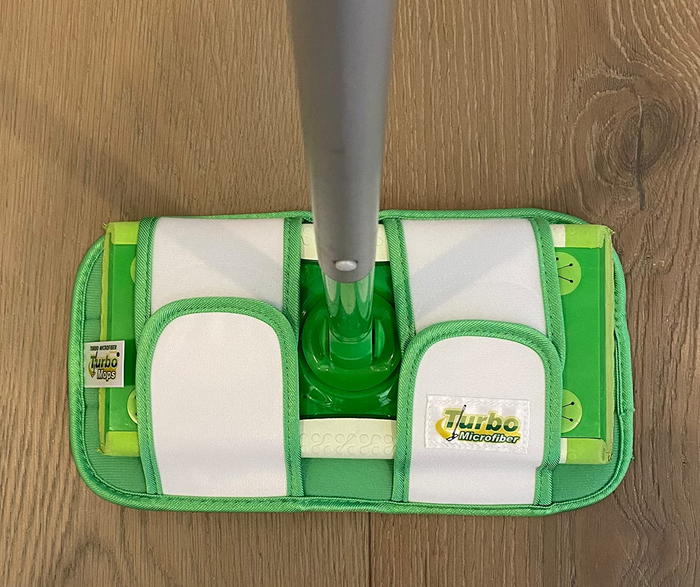 A reviewer’s photo showing the reusable mop pad attached to a Swiffer Sweeper