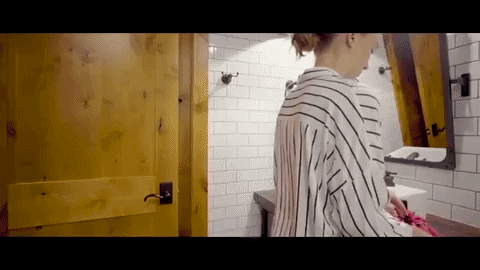 Model opening the Lay-n-Go bag, which lays flat with all the makeup inside