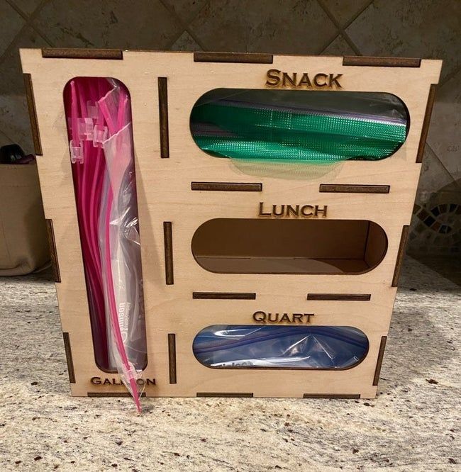 Handmade wooden sandwich bag dispenser placed neatly on the counter
