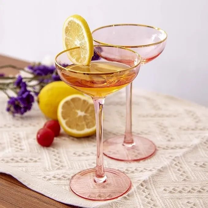 Two elegant stem glasses with a slice of lemon on one, resting on a lace tablecloth for a sophisticated decor piece