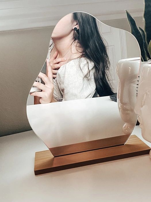 A reviewer taking a selfie in the cloud mirror.