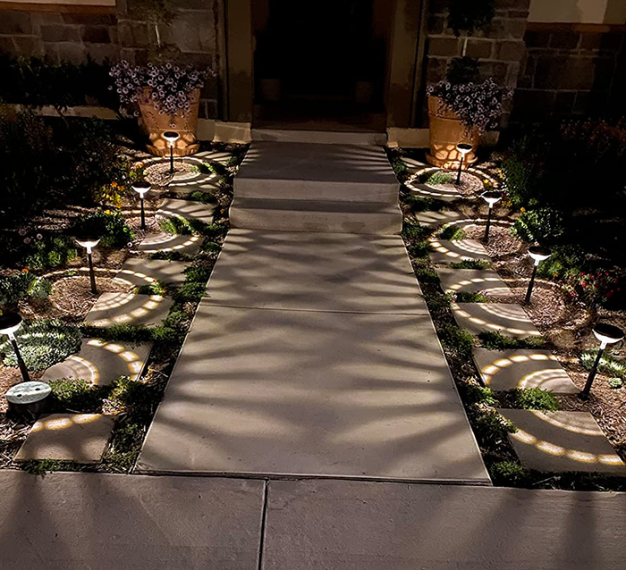 A photo from a reviewer of the lights lining a walkway, casting a bright white glow